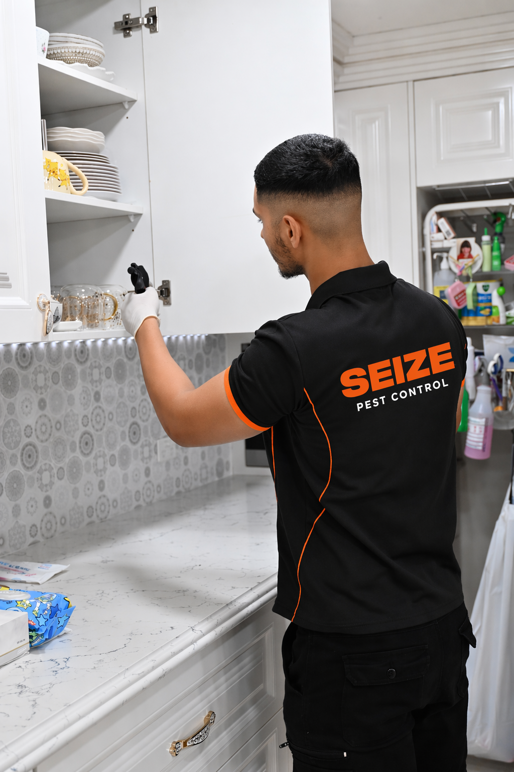 SEIZE Pest Control technician inspecting a kitchen